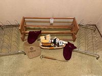 Full view of two metal shoe holders, two wood shoe racks, shoe horn with horse head handle, and basket of shoe care products and cloth bags.