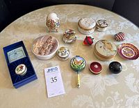 Overview of all trinket boxes and decorative dish arranged on table