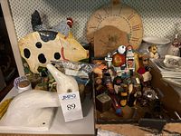 Wide view showing ceramic pig with chicken figure on its back, miniature items in boxes, and wooden clock backdrop.