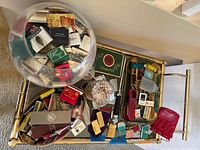 Tray holding assortment of matchbooks, lighters, cigar cutter