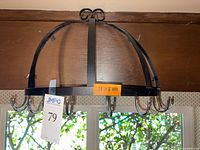 Photo of metal pot rack hanging with six hooks, black finish, size label attached