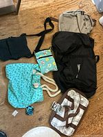 Group shot of all seven assorted bags and pouch on floor