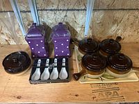 Group shot showing canisters, soup crocks, tray, tasting spoons box and tall clear vessel