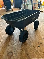 Side view of Gorilla garden cart showing plastic bed and four pneumatic tires
