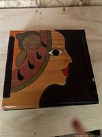 Closed box showing hand-painted lid artwork