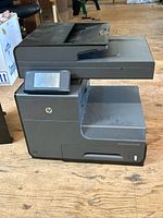 Front angled view of HP Officejet Pro X476dw printer and extra tray
