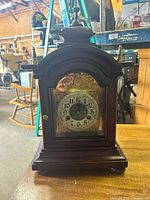 Full view of wooden mantel clock front