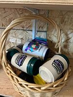 Basket containing several Disney resort mugs