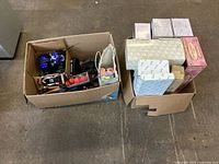 Two boxes showing overall lot contents, loose toys left, boxed items right