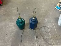 Green and navy blue ceramic lamp bases with cords and harps