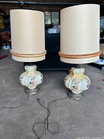 Both table lamps standing side by side with shades attached