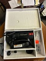 Open case showing RotoZip Rebel saw and accessories neatly stored
