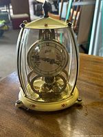 Front view of Schatz 400-day clock showing dial, floral motifs, and glass case