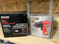 Front of both product boxes showing Sears battery charger and Central Pneumatic impact wrench