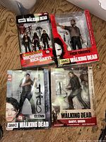 Group shot of four sealed Walking Dead action figure boxes