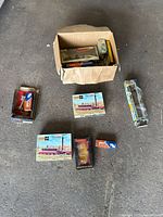 Lot overview with box of mixed model train items and separate boxes on floor