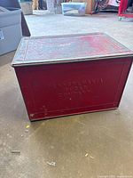 Front view of red metal box showing embossed "PENNSYLVANIA SUGAR COMPANY" lettering and wear