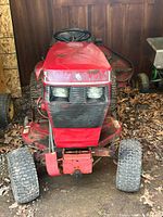 Front view showing grille, headlights, body, tires