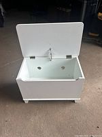 Chest open showing interior, safety hinge, ventilation holes