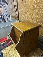 Front view showing oak cabinet, magazine rack, brass lamp pole