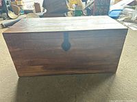 Closed view of wooden chest front showing latch