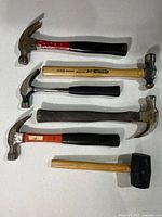 Full view of six hammers arranged on surface