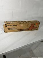 Closed cardboard box labeled Black & Decker electric hedge trimmer