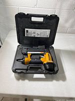 Nailer inside molded carrying case with manual
