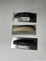 All three notched trowels front view