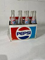 Front view of carrier holding all eight bottles