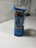 Front view of packaged Protecto Lock door knob set showing brand and warranty text