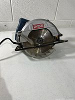 Front view showing Ryobi branding, blade, guard and cord