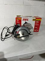 Circular saw with power cord in front of original box