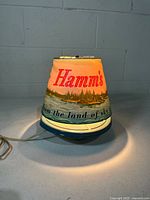 Lamp front showing Hamm's logo and scene