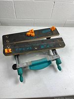 Top view of Wolfcraft clamp table showing jaws, orange clamp dogs, printed scale