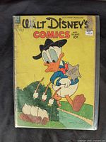Front cover of 1953 Walt Disney's Comics and Stories issue #157 featuring Donald Duck in cowboy attire with cotton plants in foreground.