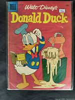 Front cover of 1958 Walt Disney's Donald Duck comic showing Donald Duck with cookbook and frosting machine illustration.