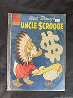 Front cover of the 1962 Walt Disney Uncle Scrooge comic issue #39 showing Uncle Scrooge wearing a Native American headdress and smoking a peace pipe, blue background, Dell brand, 12 cent price, used condition with visible wear.