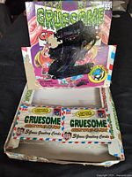 Cardboard vendor box for 1992 Topps Gruesome Greeting Cards with two sealed wax packs visible inside