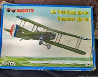 Photo of the Maquette De Havilland DH-9a model airplane kit box, showing box art of a green biplane with roundel markings.