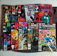 Top-down photo showing ten Punisher comic books arranged in two rows with clear visibility of cover art and titles.