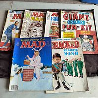 Six MAD magazines displayed, showing front covers with various illustrations and logos.