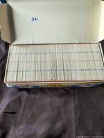 Open box showing a large collection of hockey cards, mostly 1990s, neatly stacked inside.