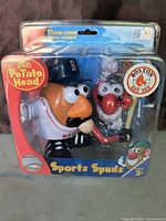 Photo shows the original sealed Mr. Potato Head Sports Spuds toy with Boston Red Sox branding and accessories visible through package.