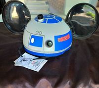 Full view of the limited edition Disney R2-D2 cap with original tags attached and Mickey Mouse ears
