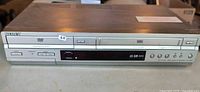 Front view of Sony SLV-D350 showing DVD tray on left, VHS slot on right, and front panel buttons.