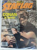 Front cover of Starlog magazine featuring Arnold Schwarzenegger as Conan the Barbarian with visible autograph signature.