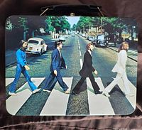 Front view of the metal lunch box lid showing The Beatles Abbey Road image