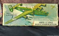 Top view of vintage Airfix B-24J Liberator airplane model kit box with illustrated artwork of the green multi-engine bomber aircraft in flight.