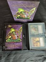 Full view of the World of Warcraft trading card game box and included cards in plastic storage cases.